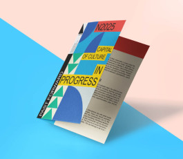  A folded brochure with a colorful geometric design featuring text: N2025 Capital of Culture in Progress and Past Forward. The inside shows a textured page with text in a clean modern font. Shadows create a dynamic look on a blue and peach background.